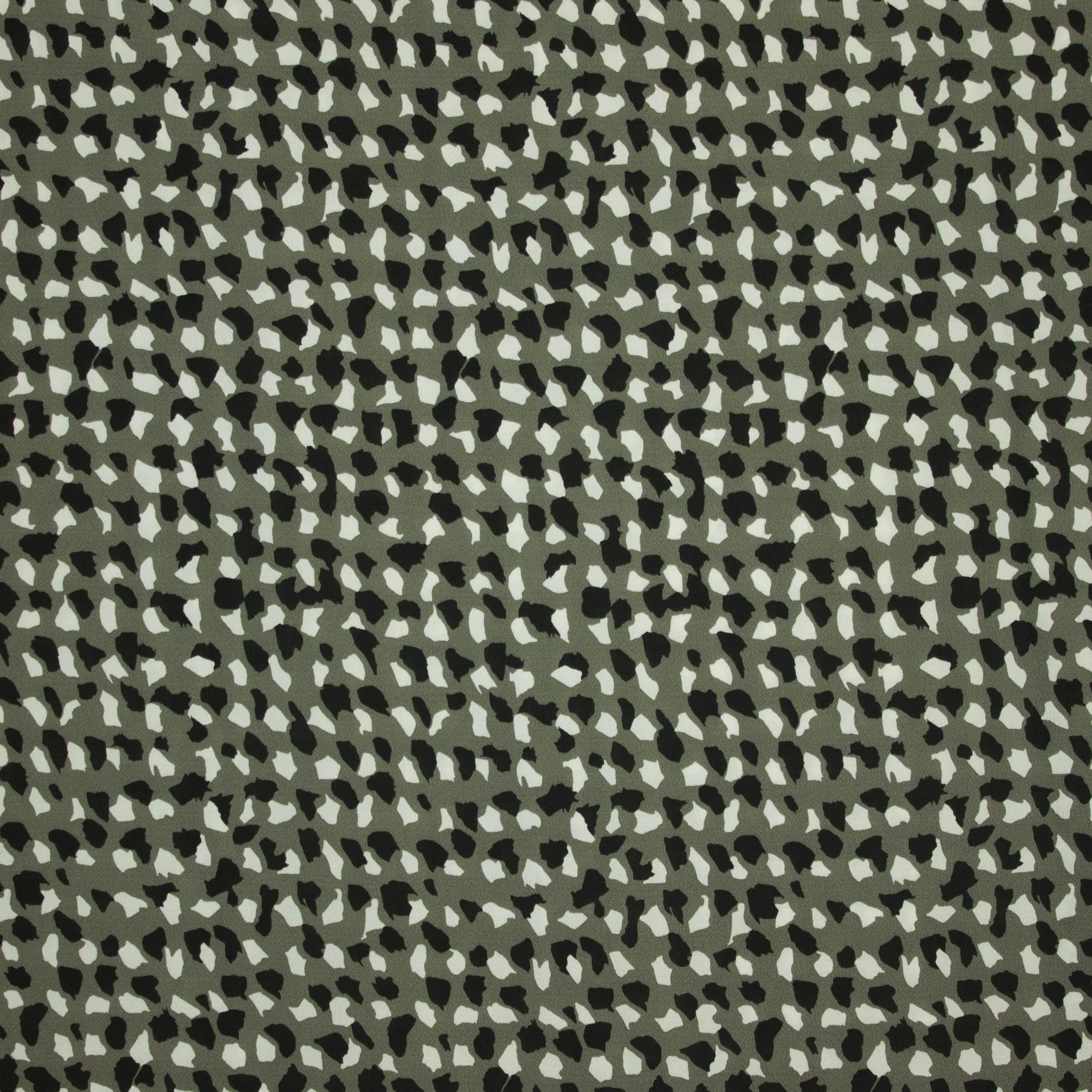 Polyester crêpe groen met witte en zwarte stippen